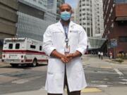 Alister Martin, an emergency room doctor at Massachusetts General Hospital, poses outside the hospital, Friday, Aug. 7, 2020, in Boston. Martin founded the organization &quot;VotER&quot; to provide medical professionals voter registration resources for patients who are unregistered voters.