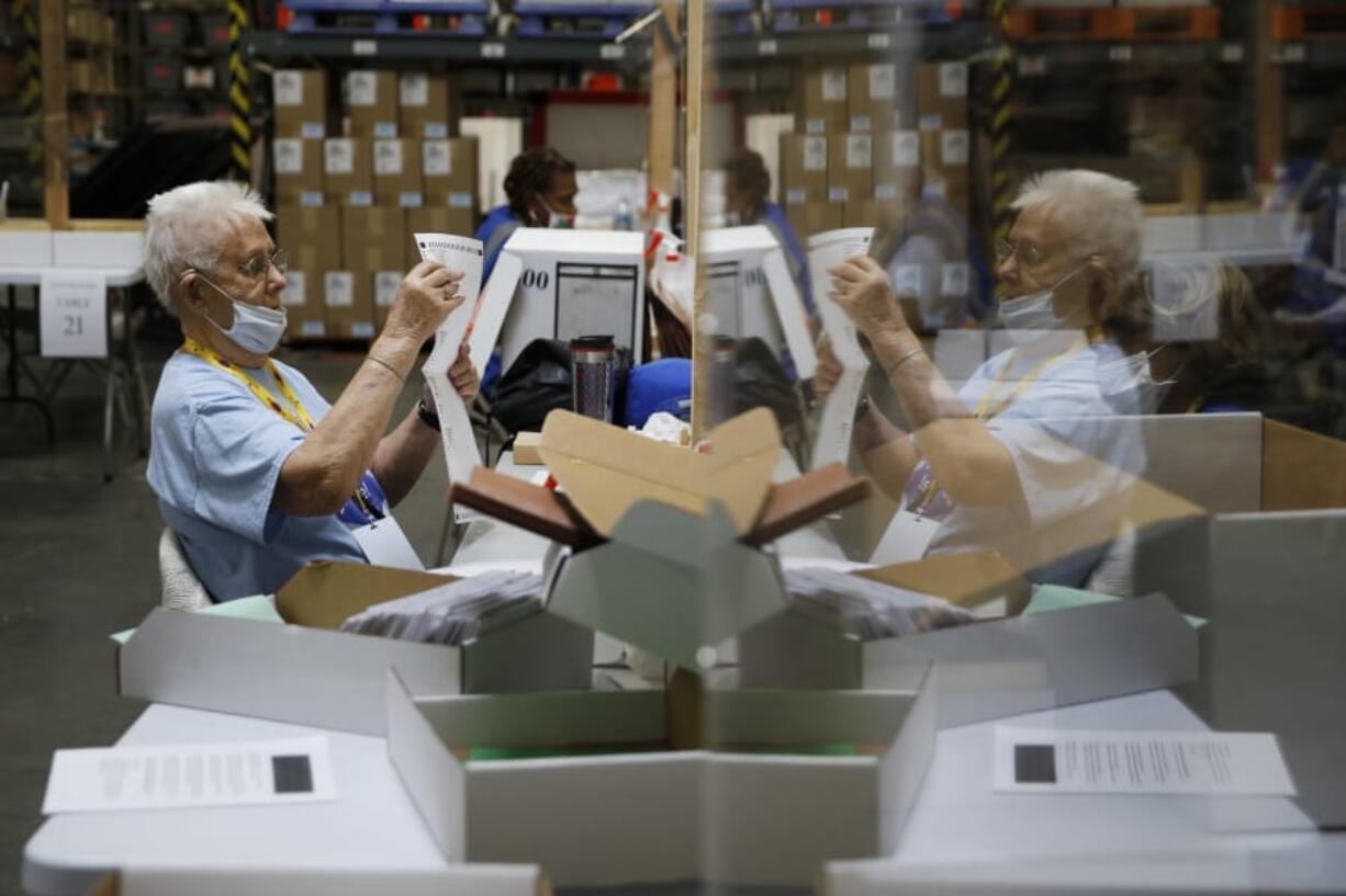 FILE - In this June 9, 2020, file photo election workers process mail-in ballots during a nearly all-mail primary election in Las Vegas. As President Donald Trump&#039;s reelection campaign challenged Nevada&#039;s new voting law in court, the president and Republicans argued the rules would facilitate fraud and illegal voting. Chief among their volley of criticism was the law&#039;s provision allowing &quot;ballot harvesting.&quot; The Nevada lawsuit highlighted a practice that has long fueled Republicans&#039; suspicions about the dangers of mail-in voting.