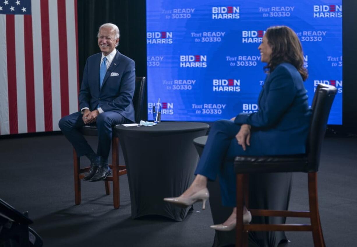 FILE - In this Aug. 12, 2020, file photo Democratic presidential candidate former Vice President Joe Biden and his running mate Sen. Kamala Harris, D-Calif., participate in a virtual grassroots fundraiser at the Hotel DuPont in Wilmington, Del. The Democratic Party will convene Monday, Aug. 17, sort of, amid a pandemic that has upended the usual pomp-and-circumstance of presidential nominating conventions.