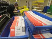 Ballots sit in sorting trays Aug. 5 at the King County Elections headquarters in Renton. (ted s.