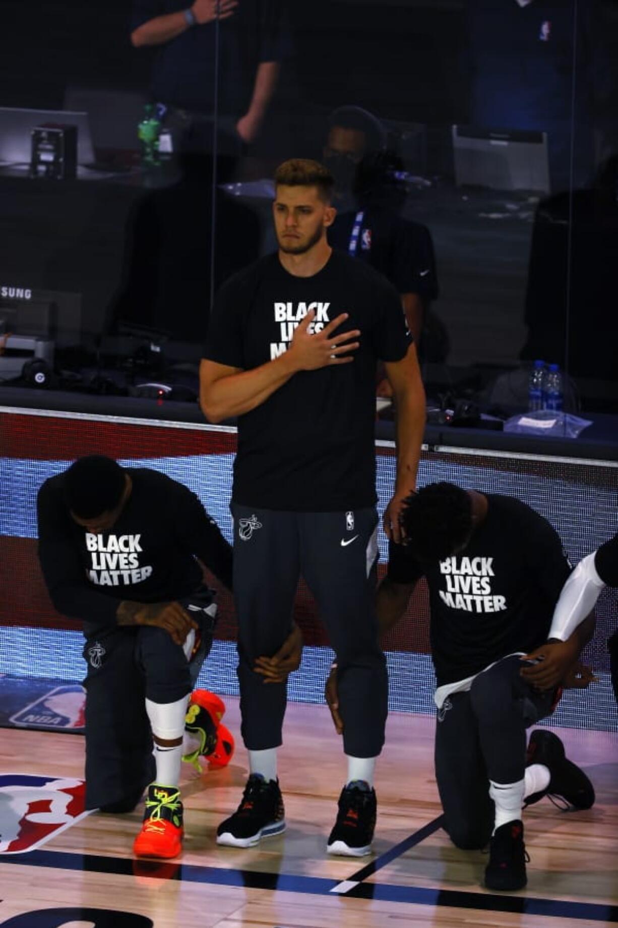 Miami Heat&#039;s Meyers Leonard stands during the national anthem before an NBA basketball game against the Denver Nuggets, Saturday, Aug. 1, 2020, in Lake Buena Vista, Fla. (Kevin C.