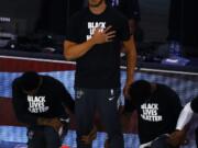 Miami Heat&#039;s Meyers Leonard stands during the national anthem before an NBA basketball game against the Denver Nuggets, Saturday, Aug. 1, 2020, in Lake Buena Vista, Fla. (Kevin C.