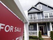 In this April 1, 2020 photo, a &quot;For Sale&quot; sign stands in front of a home that is in the process of being sold in Monroe, Wash., outside of Seattle.