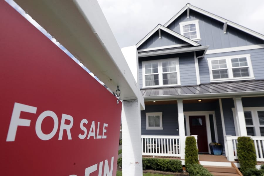 In this April 1, 2020 photo, a &quot;For Sale&quot; sign stands in front of a home that is in the process of being sold in Monroe, Wash., outside of Seattle.