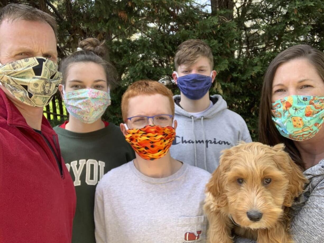 The Stile family and their dog Josie, who have taken online training classes, pose for a photo in Ellicott City, Md. Both trainers and owners are finding that online dog training is effective and convenient, and it&#039;s a safe way to learn needed skills when in-person lessons are not possible.