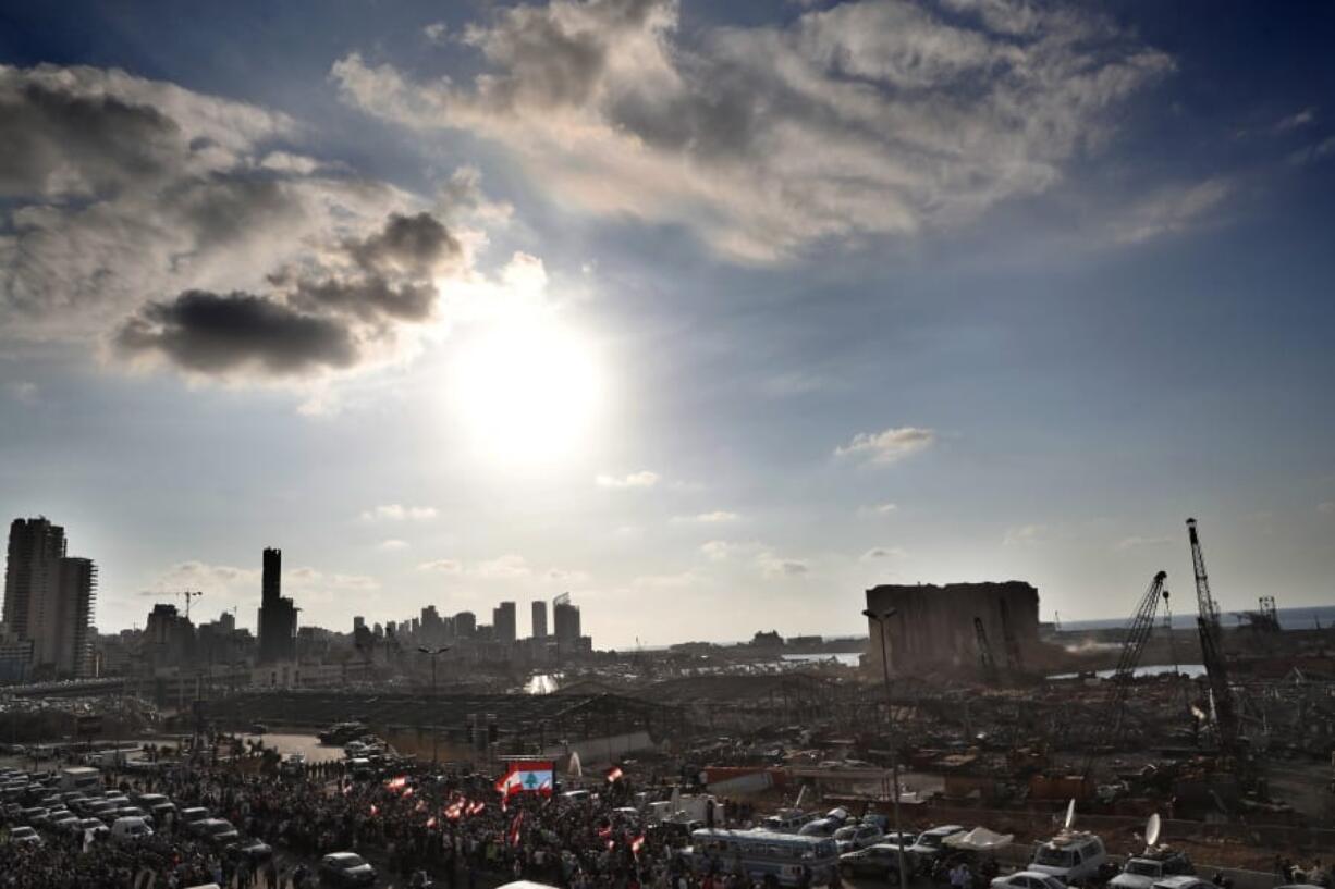 People gather in honor of the victims at the scene of the last week&#039;s explosion that killed many and devastated the city, in Beirut, Lebanon, Tuesday, Aug. 11, 2020.