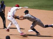 Los Angeles Angels' Andrelton Simmons, front left, is tagged out by Seattle Mariners third baseman Sam Haggerty in a rundown between first and second base during the seventh inning of a baseball game Sunday, Aug. 30, 2020, in Anaheim, Calif. Simmons drove in Albert Pujols with a single on the play.