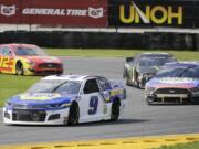 Chase Elliott (9) leads Kevin Harvick (4), Kurt Busch (1) and Ryan Blaney through Turn 3 during a NASCAR Cup Series auto race at Daytona International Speedway, Sunday, Aug. 16, 2020, in Daytona Beach, Fla.