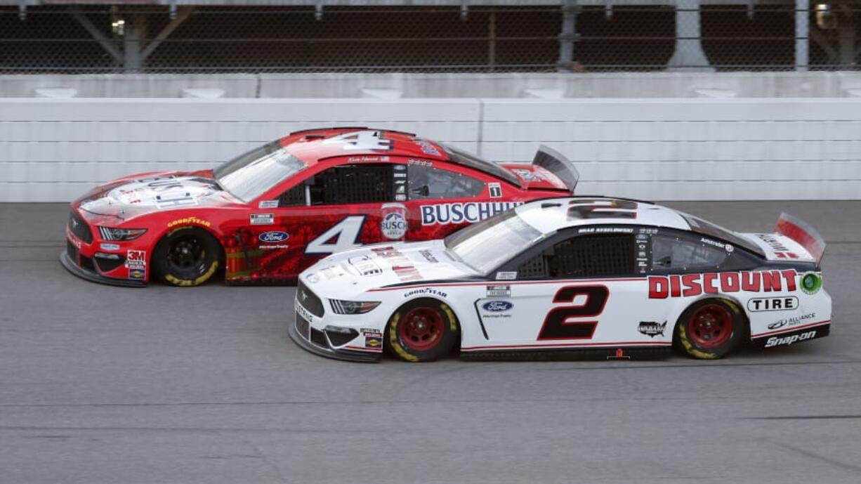 Kevin Harvick (4) competes with Brad Keselowski (2) during a NASCAR Cup Series auto race at Michigan International Speedway in Brooklyn, Mich., Saturday, Aug. 8, 2020.