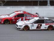 Kevin Harvick (4) competes with Brad Keselowski (2) during a NASCAR Cup Series auto race at Michigan International Speedway in Brooklyn, Mich., Saturday, Aug. 8, 2020.