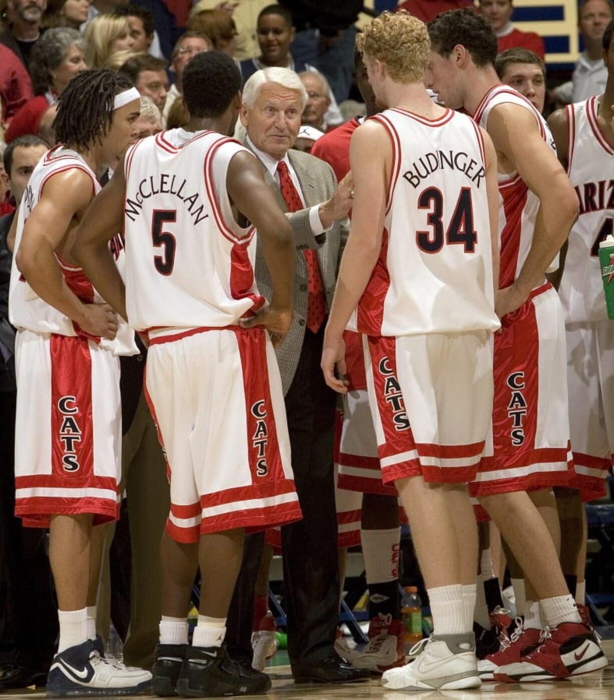 Arizona head coach Lute Olson, center, talks to his players, during a game in 2006. The Hall of Fame coach who turned Arizona into a college basketball powerhouse, died Thursday, Aug. 27, 2020, at the age of 85. Cause of death was not reported.