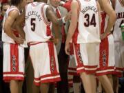 Arizona head coach Lute Olson, center, talks to his players, during a game in 2006. The Hall of Fame coach who turned Arizona into a college basketball powerhouse, died Thursday, Aug. 27, 2020, at the age of 85. Cause of death was not reported.