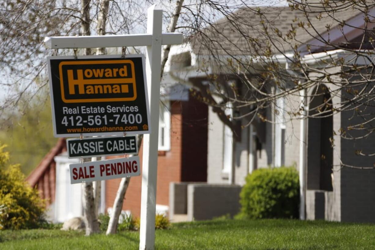 This Monday, April 27, 2020 photo shows a sale pending sign on a home in Mount Lebanon, Pa.  The number of Americans signing contracts to buy homes rose for the second straight month as the housing market appears to be recovering from a devastating spring freeze because of the coronavirus outbreak. The National Association of Realtors said Wednesday, July 29,  that its index of pending sales rose 16.6% to 116.1 in June.(AP Photo/Gene J.