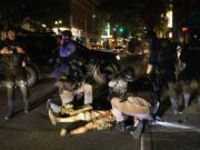 A man is being treated after being shot Saturday, Aug. 29, 2020, in Portland, Ore. Fights broke out in downtown Portland Saturday night as a large caravan of supporters of President Donald Trump drove through the city, clashing with counter-protesters.