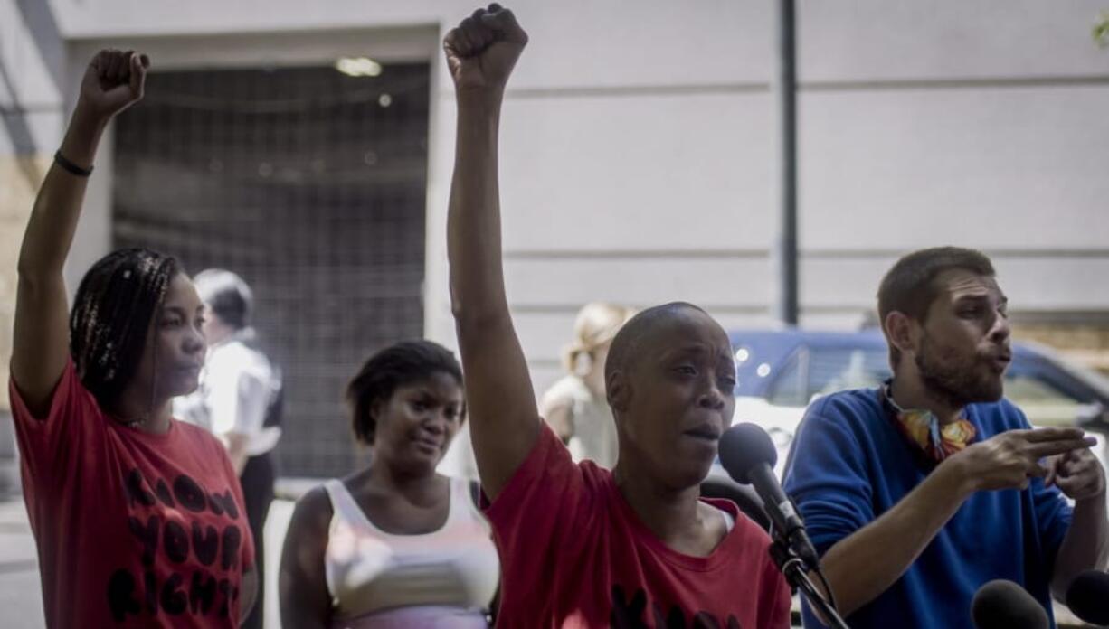 Demetria Hester, center, speaks to the media after being released from the Multnomah County Justice Center on Monday, Aug. 10, 2020, in Portland, Ore. Hester became a leading activist in the racial justice movement after she was assaulted by a white supremacist three years ago. Authorities said Hester won&#039;t be charged following her arrest early Monday. Hester had been booked on suspicion of disorderly conduct and interfering with a police officer during the protest that began Sunday night. Hester&#039;s arrest drew a sharp rebuke from national Black Lives Matter activists, who are increasingly focusing on demonstrations in Oregon&#039;s largest city.