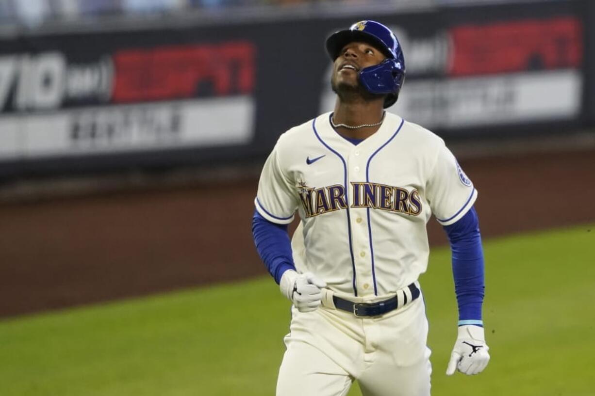 Seattle Mariners&#039; Kyle Lewis looks up as he rounds the bases after hitting a solo home run against the Texas Rangers during the first inning of a baseball game, Sunday, Aug. 23, 2020, in Seattle. (AP Photo/Ted S.