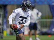 Seattle Seahawks safety Jamal Adams holds the football during a practice drill at NFL football training camp, Wednesday, Aug. 12, 2020, in Renton, Wash. (AP Photo/Ted S.