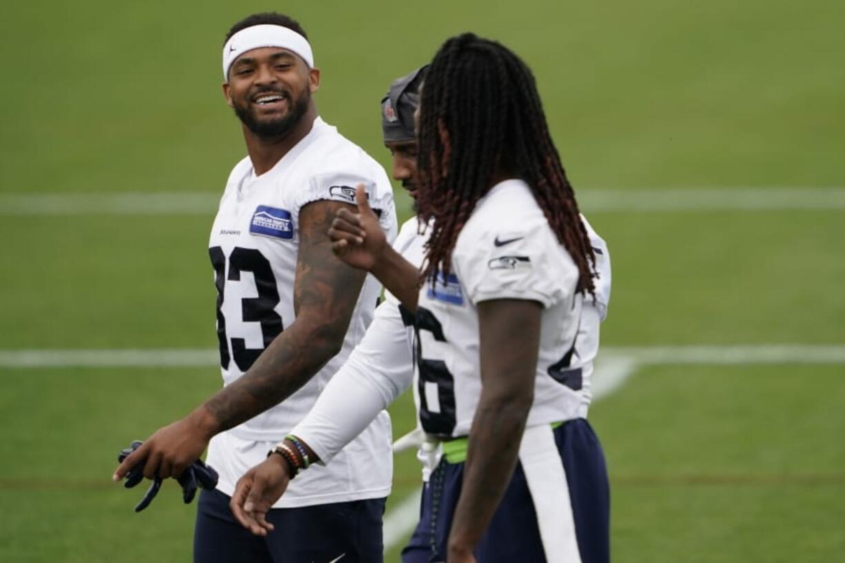 Seattle Seahawks safety Jamal Adams, left, talks with teammates Shaquill Griffin, right, and Quandre Diggs, center during NFL football training camp, Thursday, Aug. 20, 2020, in Renton, Wash. (AP Photo/Ted S.