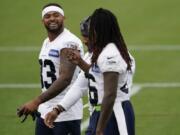 Seattle Seahawks safety Jamal Adams, left, talks with teammates Shaquill Griffin, right, and Quandre Diggs, center during NFL football training camp, Thursday, Aug. 20, 2020, in Renton, Wash. (AP Photo/Ted S.