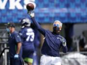 Seattle Seahawks head coach Pete Carroll throws a football during NFL football training camp, Wednesday, Aug. 12, 2020, in Renton, Wash. (AP Photo/Ted S.