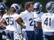 Seahawks cornerback Quinton Dunbar, center, stands at training camp in Renton. Though not revealing specifics, Dunbar spoke vaguely about an offseason arrest in Florida for alleged armed robbery. Those charges were dropped.