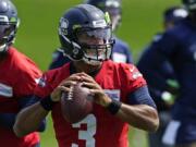 Seattle Seahawks quarterback Russell Wilson looks to pass during a practice drill at NFL football training camp, Wednesday, Aug. 12, 2020, in Renton, Wash. (AP Photo/Ted S.