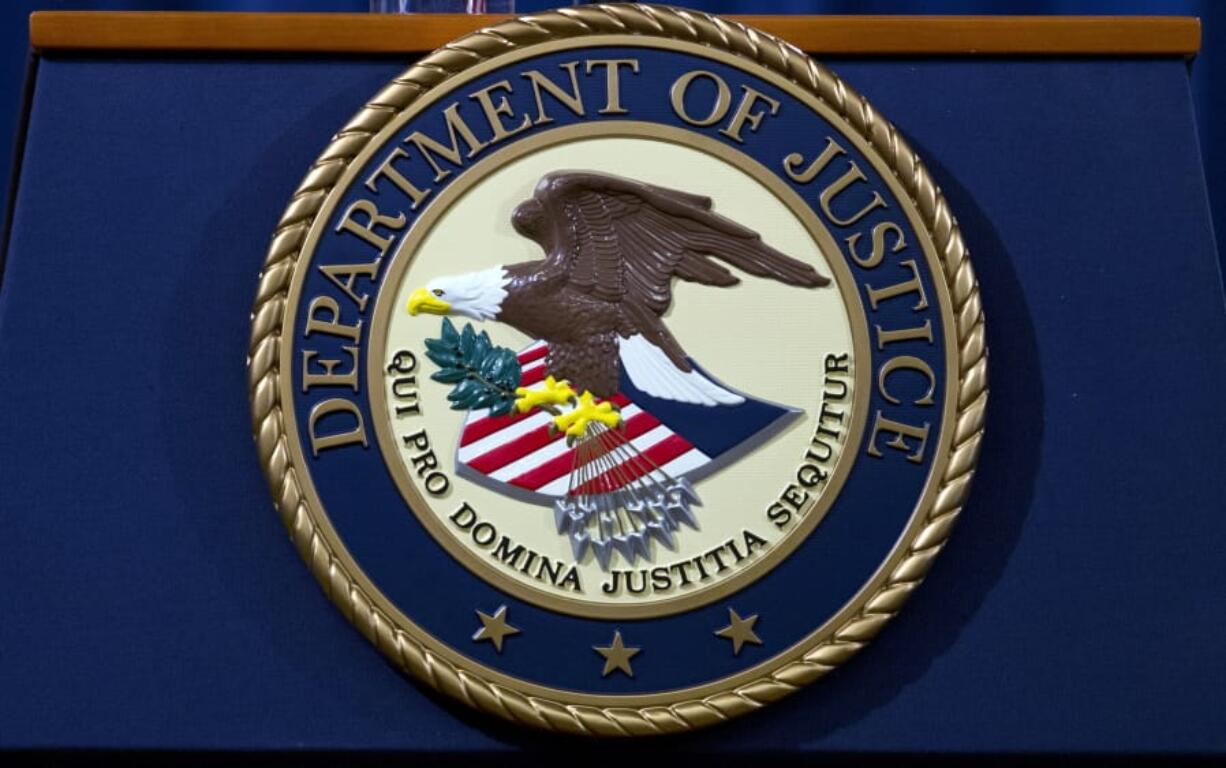 FILE - In this Nov. 28, 2018, file photo, the Department of Justice seal is seen in Washington, D.C. The Justice Department has released a new regulation spelling out detailed nationwide requirements for sex offender registration under a law Congress passed in 2006. The regulation released Monday stems from the Sex Offender Registration and Notification Act. It requires convicted sex offenders to register in the states in which they live, work or attend school.