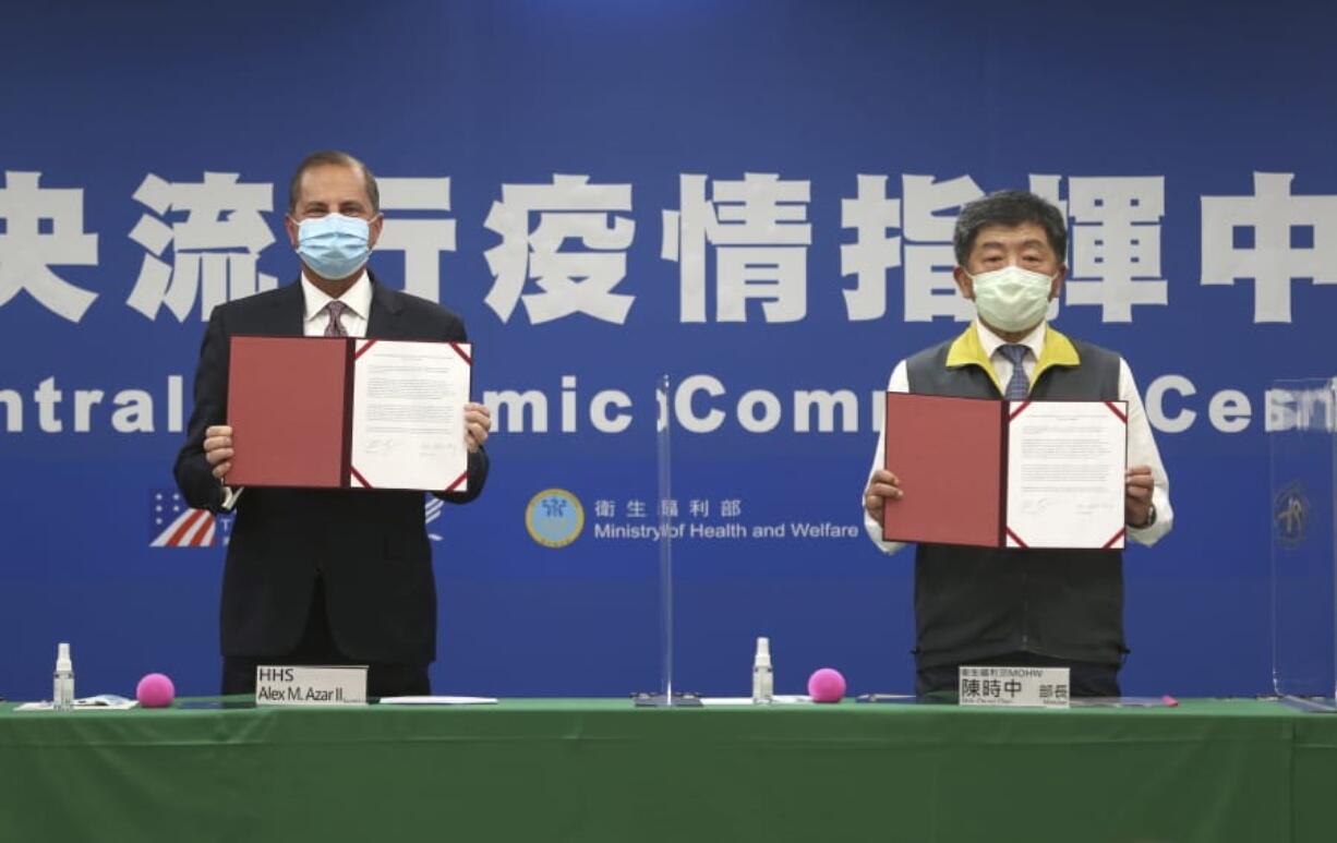 U.S. Health and Human Services Secretary Alex Azar, left, and Taiwanese Minister of Health and Welfare Chen Shih-chung pose for a photo during a signing of a memorandum of understanding at the Central Epidemic Command Center in Taipei, Taiwan, Monday, Aug. 10, 2020. Azar arrived in Taiwan on Sunday in the highest-level visit by an American Cabinet official since the break in formal diplomatic relations between Washington and Taipei in 1979.