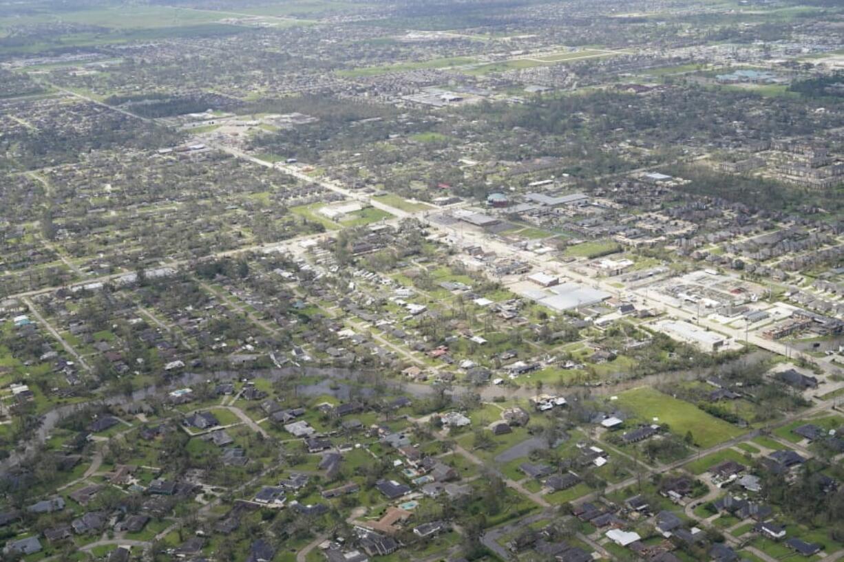 Blown down trees and debris surround damaged homes and buildings in the aftermath of Hurricane Laura Thursday, Aug. 27, 2020, near Lake Charles, La. (AP Photo/David J.