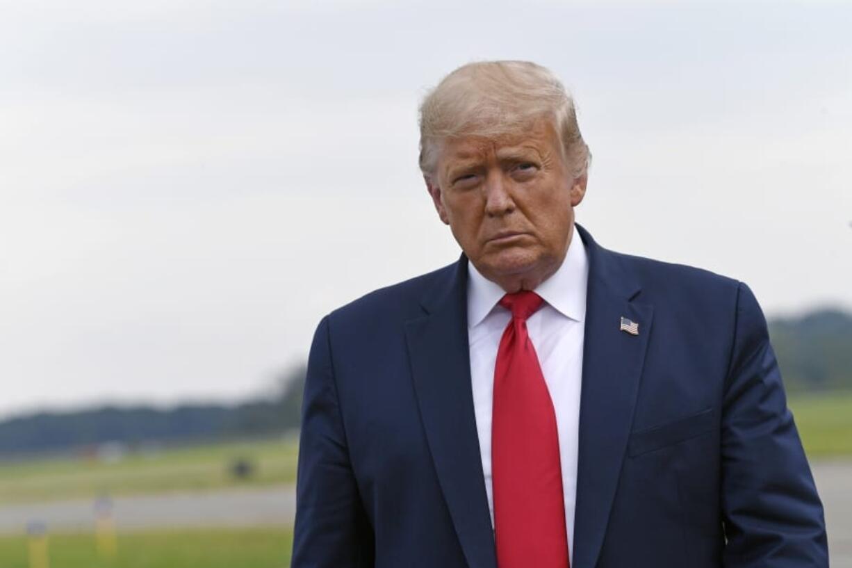 President Donald Trump walks over to speak with the press after arriving on Air Force One at Morristown Municipal Airport in Morristown, N.J., Friday, Aug. 14, 2020. Trump heading to New York to visit with his younger brother, Robert Trump, who has been hospitalized in New York.