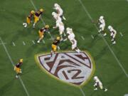 FILE - This Thursday, Aug. 29, 2019, file photo, shows the Pac-12 logo during the second half of an NCAA college football game between Arizona State and Kent State, in Tempe, Ariz. The Pac-12 has set Sept. 26 as the start of its 10-game conference-only football schedule. The Pac-12 announced three weeks ago it would eliminate nonconference games for its 12 member schools.