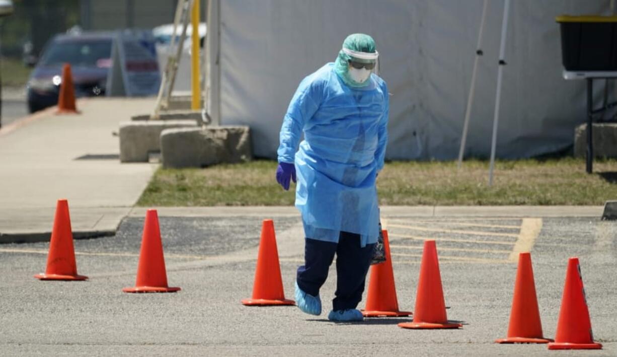 Medical personnel prepare a drive-thru COVID-19 testing site, Friday, Aug. 14, 2020, in San Antonio. Coronavirus testing in Texas has dropped significantly, mirroring nationwide trends, just as schools reopen and football teams charge ahead with plans to play.