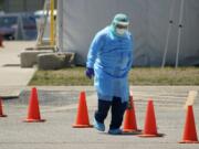 Medical personnel prepare a drive-thru COVID-19 testing site, Friday, Aug. 14, 2020, in San Antonio. Coronavirus testing in Texas has dropped significantly, mirroring nationwide trends, just as schools reopen and football teams charge ahead with plans to play.