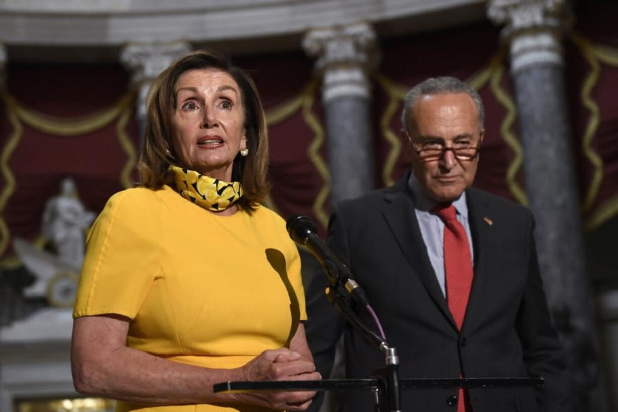 House Speaker Nancy Pelosi of Calif., left, speaks as she stands next to Senate Minority Leader Sen. Chuck Schumer of N.Y., right, on Capitol Hill in Washington, Monday, Aug. 3, 2020. Schumer and Pelosi met earlier with Treasury Secretary Steven Mnuchin and White House Chief of Staff Mark Meadows as they continue to negotiate a coronavirus relief package.