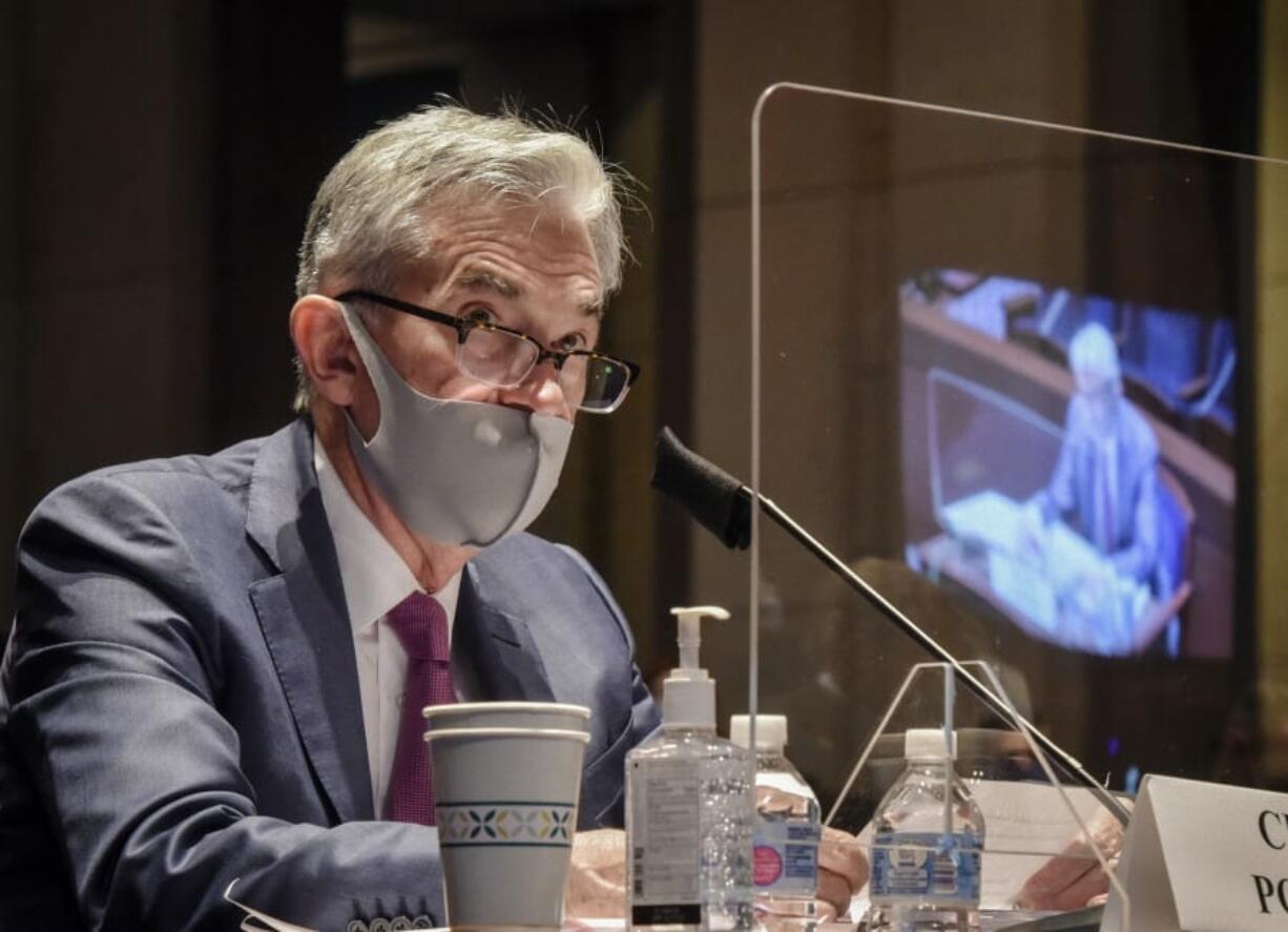 FILE - In this June 30, 2020, file photo Federal Reserve Board Chairman Jerome Powell, reflected in the sneeze guard set up between himself and members of the House Committee on Financial Services, speaks during a hearing on oversight of the Treasury Department and Federal Reserve pandemic response on Capitol Hill in Washington. With the economy still in the pandemic&#039;s grip, the Federal Reserve is facing a decision on whether to stretch an emergency lending program in a way that could bring more risk for the government and taxpayers. Lawmakers are pressing the central bank to deliver more aid to struggling small and mid-sized businesses.