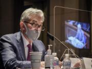 FILE - In this June 30, 2020, file photo Federal Reserve Board Chairman Jerome Powell, reflected in the sneeze guard set up between himself and members of the House Committee on Financial Services, speaks during a hearing on oversight of the Treasury Department and Federal Reserve pandemic response on Capitol Hill in Washington. With the economy still in the pandemic&#039;s grip, the Federal Reserve is facing a decision on whether to stretch an emergency lending program in a way that could bring more risk for the government and taxpayers. Lawmakers are pressing the central bank to deliver more aid to struggling small and mid-sized businesses.