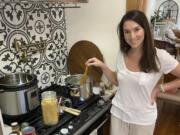 This July 26, 2020 photo shows Erika Navarrete Nagle, a television producer in Denver, Colo., preparing a meal for her family in Denver. Before she began quarantining in late March, the 33-year-old had never cooked chicken. &quot;I was a mess in the kitchen,&#039;&#039; she says. &#039;&#039;I grew up in a Cuban family with a mother and sister who always cooked for me. You&#039;d think I picked up a thing or two, but I&#039;ve always been a workaholic and I never made time nor had the desire to cook.&quot; &quot;It took a global pandemic and mandatory quarantine for me to learn,&quot; she says.