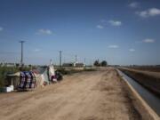 This July 24, 2020, photo shows a homeless encampment near a canal in El Centro, Calif. As support services have dwindled amid the COVID-19 pandemic, some homeless people in Imperial County have resorted to bathing in irrigation canals. Homelessness looks different in different parts of the U.S., especially in rural agricultural regions such as Imperial County.