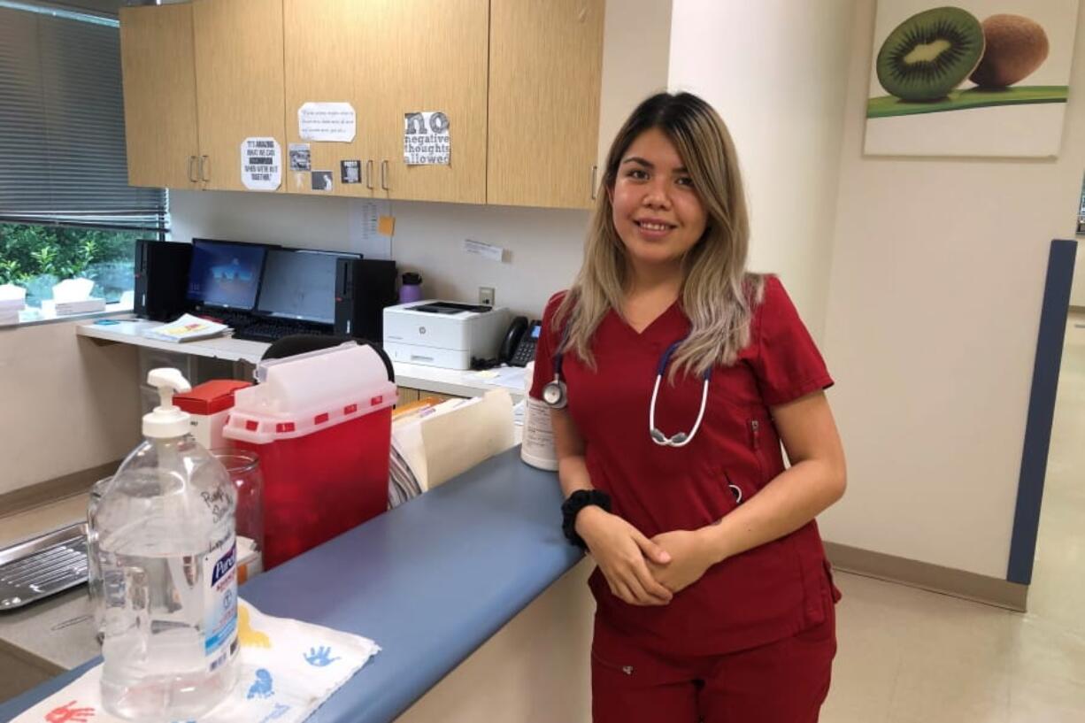 Claudia Guzman poses for a photo inside the medical clinic where she works July 22, 2020, in Memphis, Tenn. When Guzman suspected she had caught the coronavirus, her friends and family were full of advice: Don&#039;t quarantine. Don&#039;t get tested. A homemade tea will help cure you. Among Latinos in the U.S., misinformation around the coronavirus has found fertile ground because many in their communities have higher levels of distrust in government, less access to medical care and may need to be reached by Spanish-language public health resources.