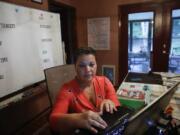 Aimee Rodriguez Webb works on her computer Tuesday at her dinning room table that she set up as a virtual classroom for a Cobb County school in Marietta, Ga. After a rocky transition to distance learning last spring, Webb is determined to do better this fall.