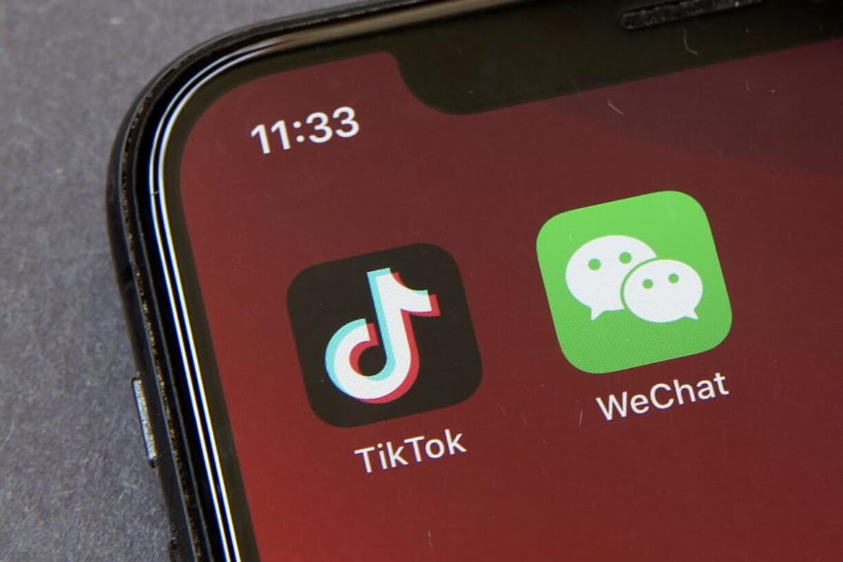 FILE - Icons for the smartphone apps TikTok and WeChat are seen on a smartphone screen in Beijing, in a Friday, Aug. 7, 2020 file photo.  Some U.S.-based users of WeChat are suing President Donald Trump in a bid to block an executive order that they say would effectively prohibit U.S. access to the popular Chinese messaging app. The complaint was filed Friday, Aug. 21, 2020 in San Francisco and asks a federal court judge to stop Trump&#039;s order from being enforced. It claims a ban would violate U.S. users&#039; constitutional rights.