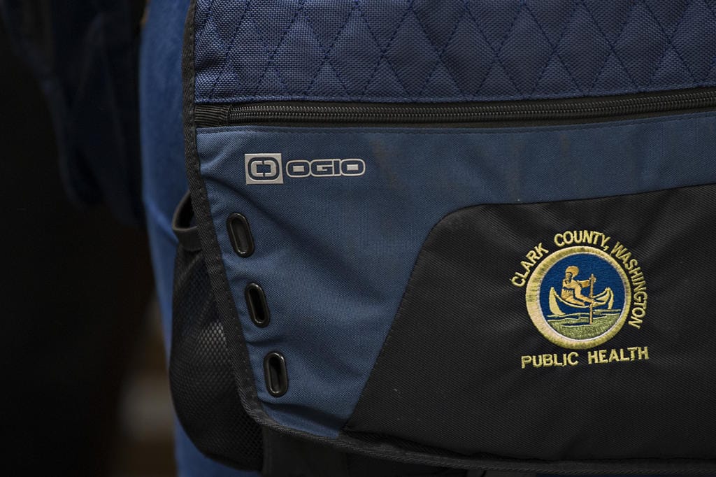 A patch is seen on the bag of Clark County Public Health Environmental Health Specialist Maggie Yaddof before inspecting the Fargher Lakehouse in Yacolt on Jan. 13.