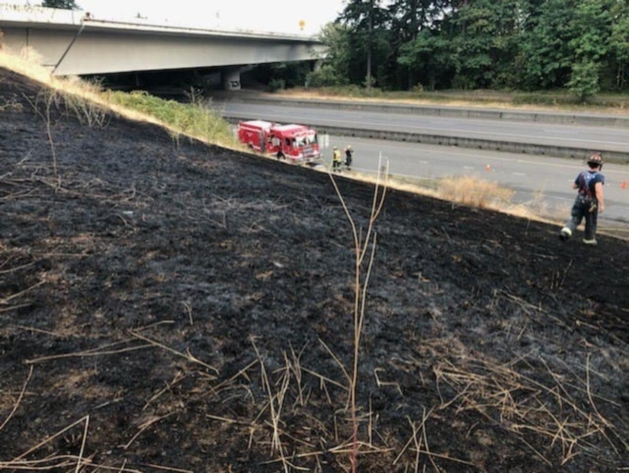 A vehicle fire on state Highway 14 spread to nearby grass Wednesday evening, burning about an acre before being brought under control by the Vancouver Fire Department.