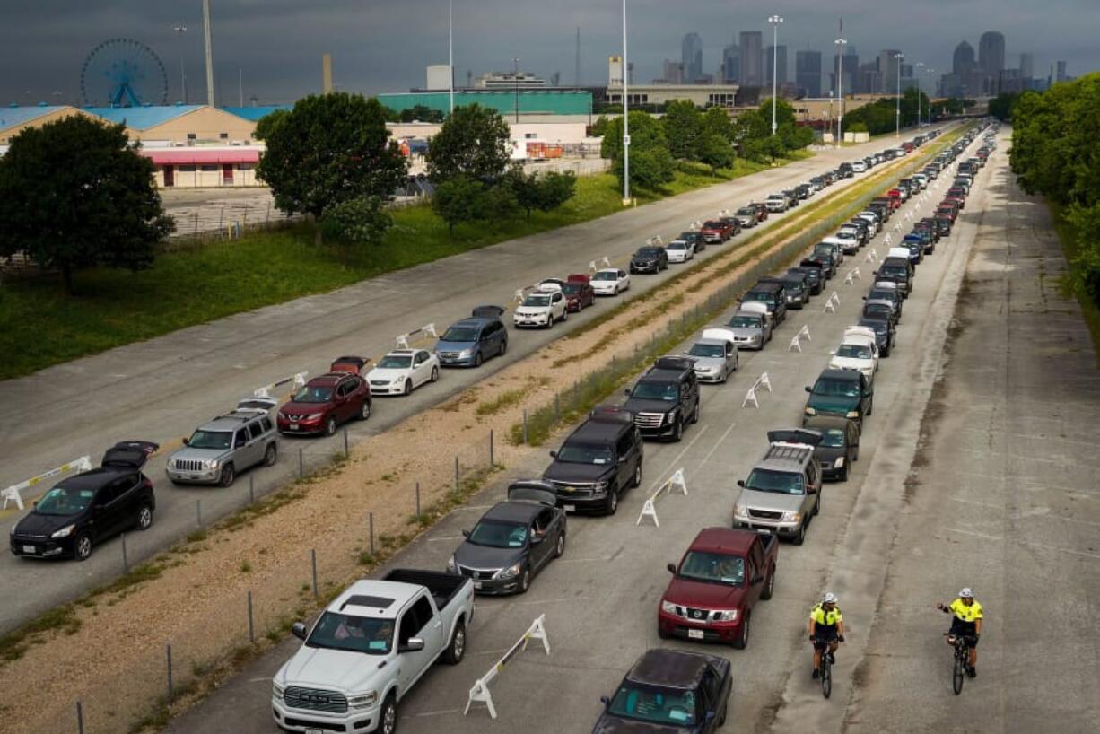 Cars line up for a food distribution the North Texas Food Bank conducted at Dallas&#039; Fair Park on May 14. (Smiley N.