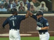 Seattle Mariners&#039; Kyle Seager, right, is congratulated by teammate Kyle Lewis after hitting a two-run home run off of Texas Rangers starting pitcher Kolby Allard during the first inning Monday in Seattle. The Mariners have won six straight games for the first time since July 2019.