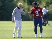 Seattle Seahawks quarterback Russell Wilson (3) bumps fists with head coach Pete Carroll after practice last week in Renton. With Wilson in the prime of his career and surrounded by weapons on offense, the Seahawks are once again contenders in the NFC. (Ted S.