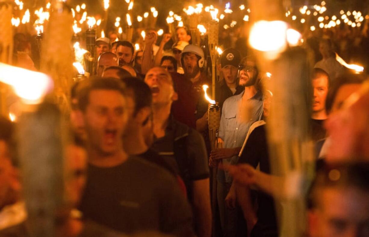 Neo-Nazis, alt-right and white supremacists march through the University of Virginia in Charlottesville, Va., the night before the &quot;Unite the Right&quot; rally on Aug. 11, 2017. (zach d.