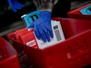 Ballots are processed at the King County Elections headquarters in Renton for Washington stateCfUs primary election on March 10, 2020. Though gloves have always been optional for elections workers, it has become mandatory to prevent COVID-19.