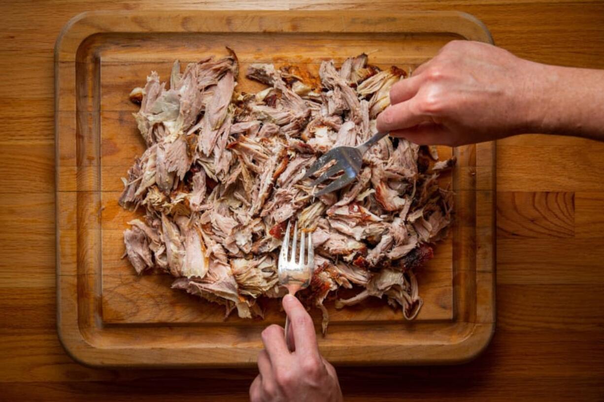 Once you can touch the pork shoulder without it burning you, pitmaster Daniel Castillo says, &quot;that&#039;s when you know it&#039;s perfect.&quot; (Jay L.