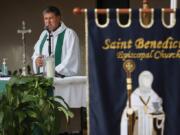 The Rev. Albert Cutie conducts church service outside St. Benedict&#039;s Episcopal Church on Sunday in Plantation, Florida as the congregation adapts to the COVID-19 pandemic. St. Benedict&#039;s Episcopal Church held drive-in movie style services as cars parked and listened on their car radios.